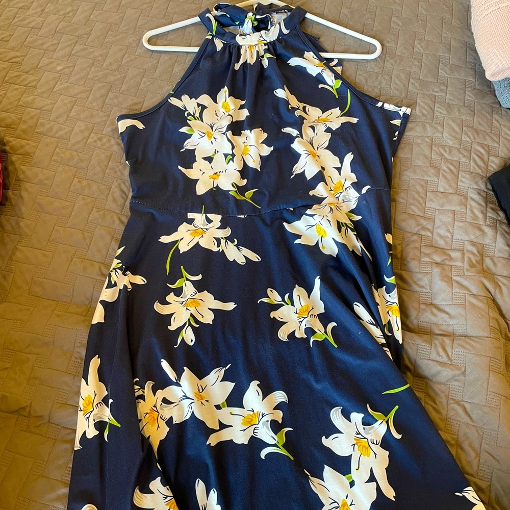 Blue sundress with white and yellow flowers.